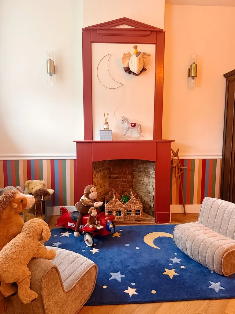 The red fireplace above a deep blue rug of moon and stars